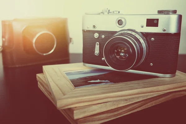 Retro vintage camera and photo frames on wood table