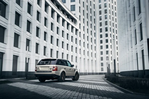 Car Land Rover Range Rover stand near modern building in Moscow city at daytime