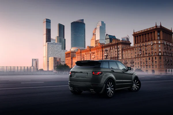 Car Land Rover Range Rover Evoque standing on asphalt road in city Moscow at sunset