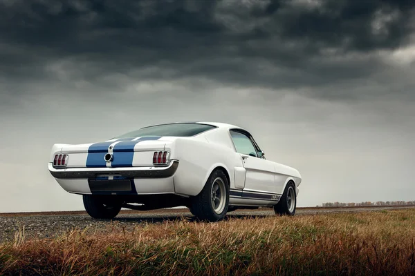 Retro muscle car ford mustang shelby on the road