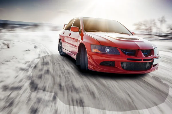 Fast drive car speed on the road turn at winter mitsubishi lancer evolution