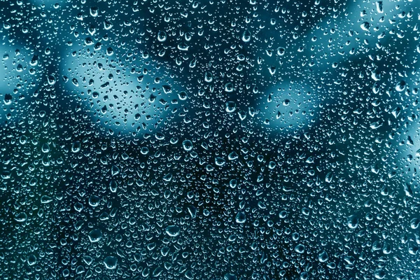 Rain water drops on transparent wet glass