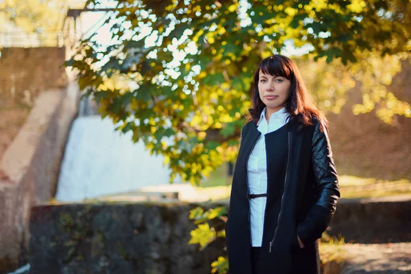 Beautiful girl 30 years in business suit walking in the autumn forest