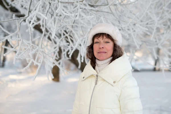 Beautiful woman 50 years old walking on the snowy city
