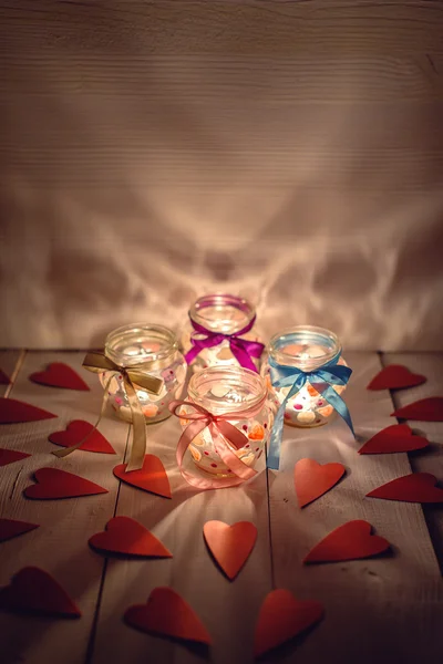 Glass jars with candles for Valentine\'s Day