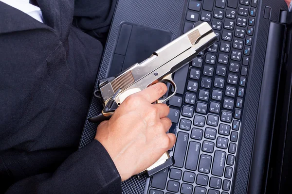 Close up of woman in business suit holding a gun back side