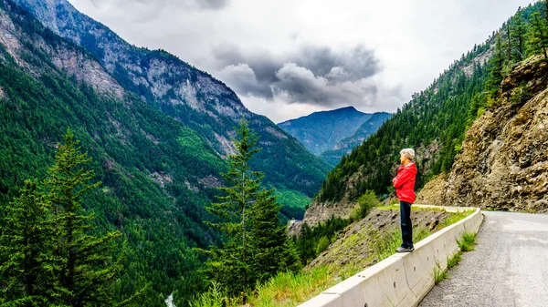 Senior Woman enjoying the View along Highway 99, the Duffy Lake Road, in British Columbia