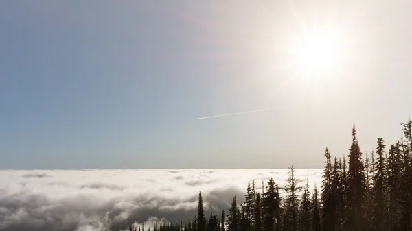 View from the high mountain top over cloud covered valley