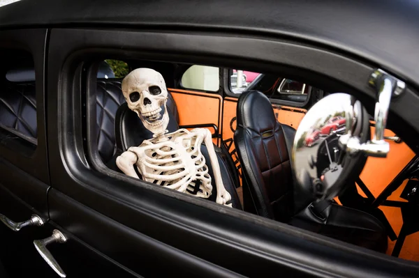 Laughing Skeleton as a Passenger in an Old Car
