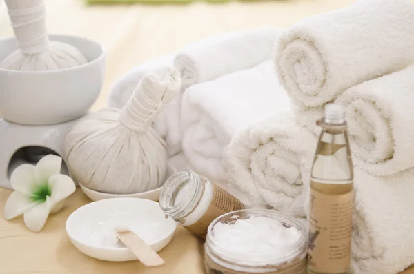 Spa treatment with towels and herbal creams