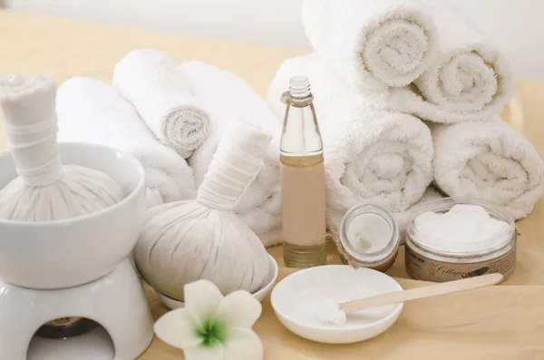 Spa treatment with towels and herbal creams