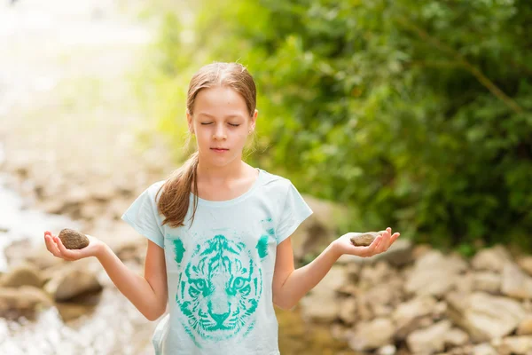 Young Yoga Girl meditating at sunrise