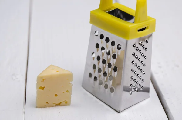 Piece of cheese with a grater