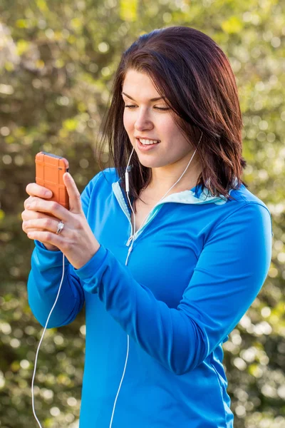 Woman exercising and listing to music.