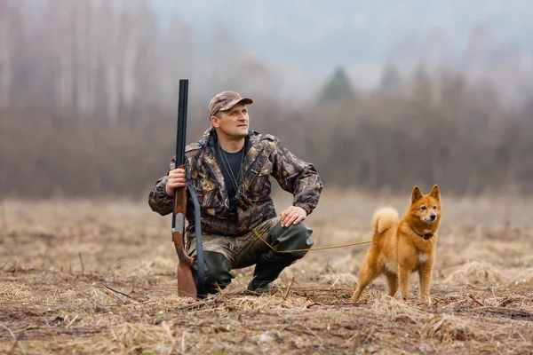 The hunter with a gun and a dog