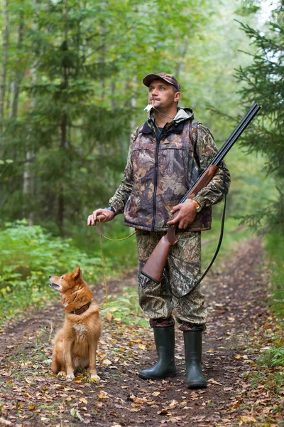 Man with dog out hunting for hazel grouse