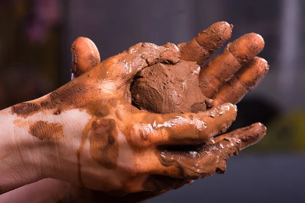 Closeup of hands of a potter with clay