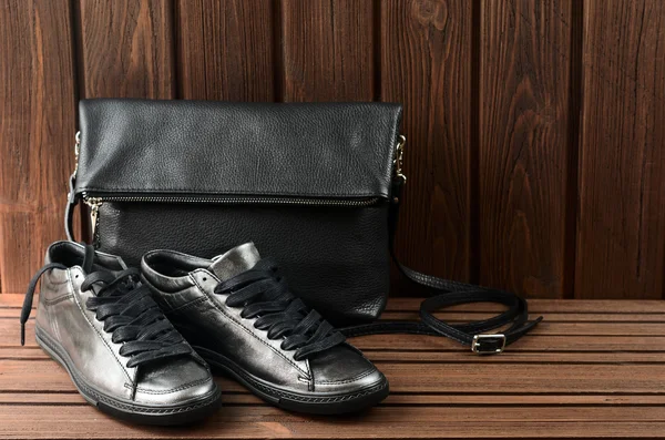 Leather upper metallic womens shoes and black leather bag on bro