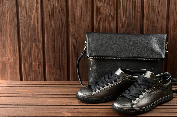 Leather upper metallic womens shoes and black leather bag on bro