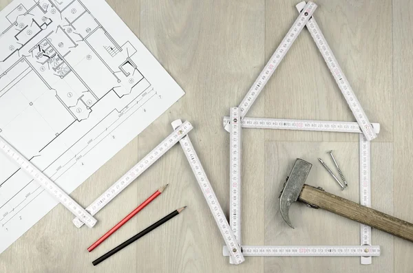 White meter tool forming a house and engineering tools on woode