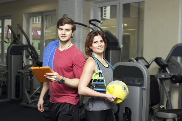 Beautiful sports fitness couple in the gym