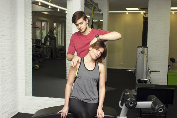 Beautiful sports fitness couple in the gym. Fitness instructors with additional equipment