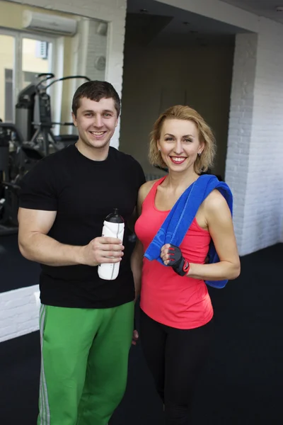 Fitness smiling couple in gym