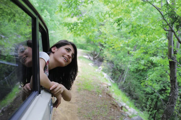 Young woman in the forest travel with happiness.