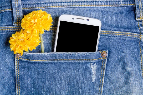 Smart phone and plastic flowers in the back pocket jeans.Jeans b