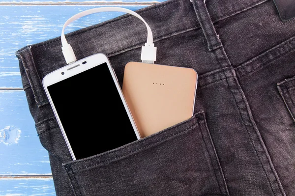 Mobile phone portable battery recharging a smartphone in pocket