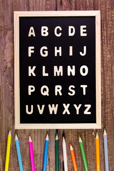 Wooden english alphabet A-Z on the blackboard.Color pencil on wo