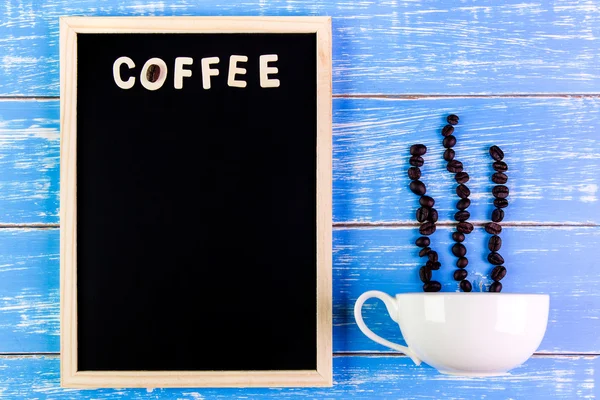 Wooden english alphabet coffee and coffee cup on the blackboard.