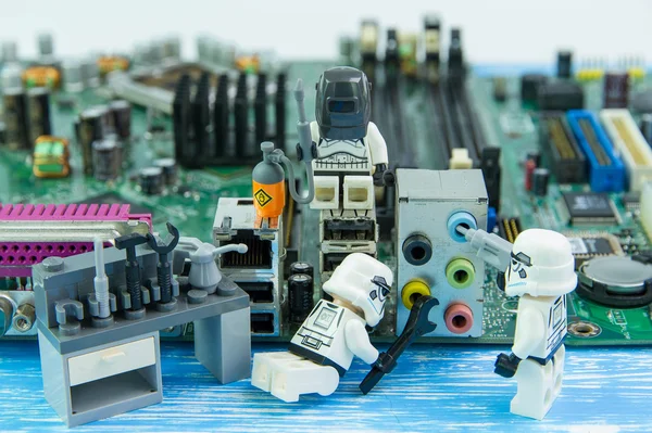Lego star wars repairing computer motherboard.
