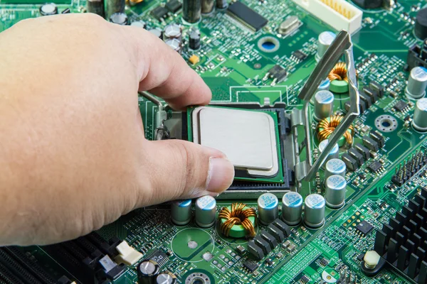 CPU in hand before installation into the motherboard