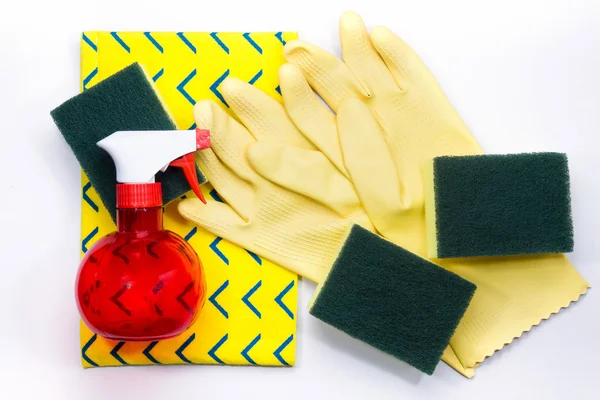 Yellow rubber gloves and scrubber sponges on yellow cleaning nap