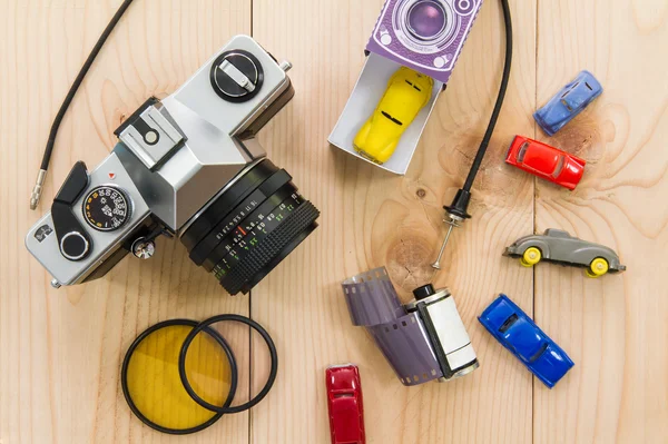 Antique cameras and photographic equipment placed on wood.