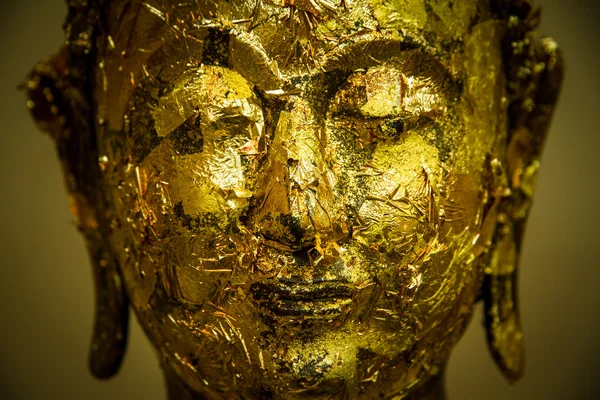 Close up face of the golden Buddha.