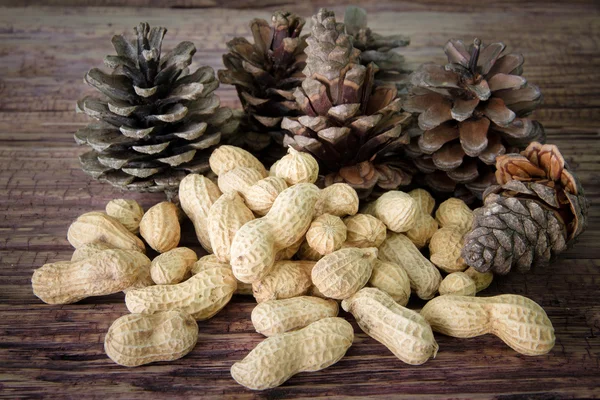 Peanuts drying and pine nuts on the wooden table