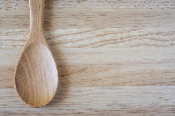 Wooden serving spoon ladle over the cutting board