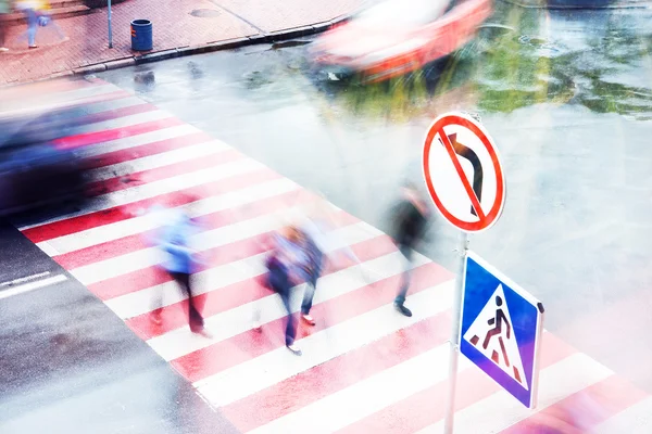 Movement of people and cars on the pedestrian crossing the intersection, blurred motion