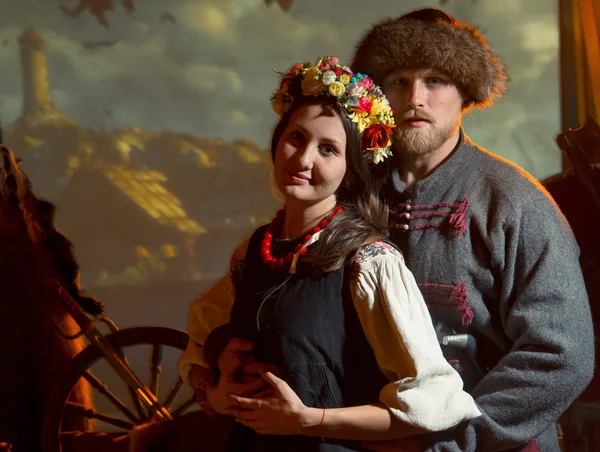 Man in an old suit Cossack and Ukrainian girl in national costume in a wreath fvetochnom