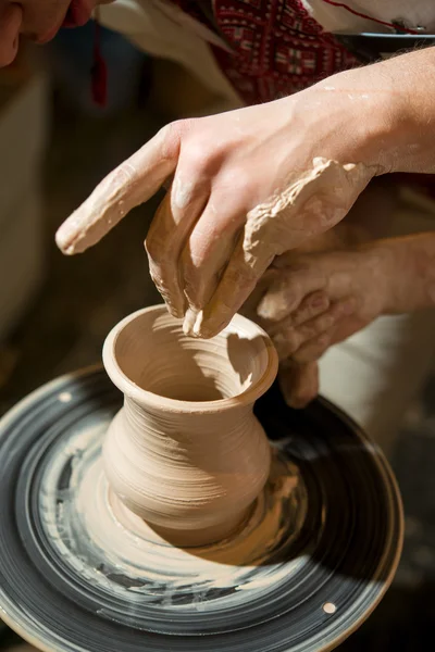 Master potter makes pitcher on a potter\'s wheel