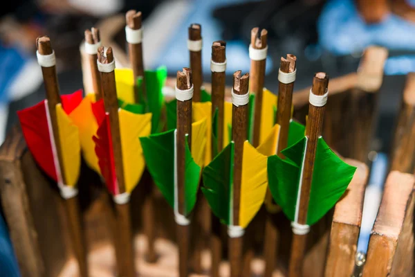 Colored feathers of the arrow in the quiver for bow