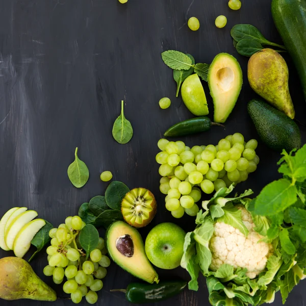 All green Vegetables and Fruits on Dark Background