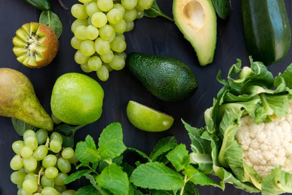 All green Vegetables and Fruits on Dark Background