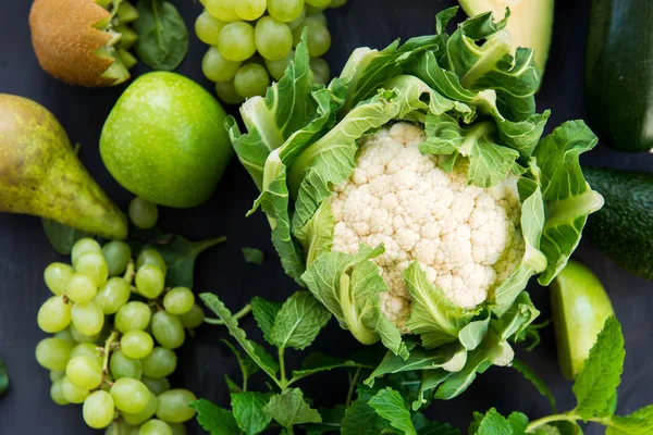 All green Vegetables and Fruits on Dark Background