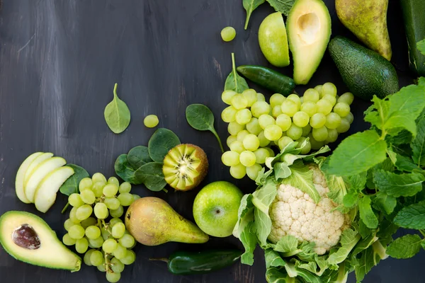 All green Vegetables and Fruits on Dark Background