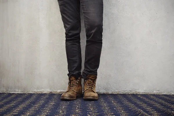 Jeans and boots on carpet