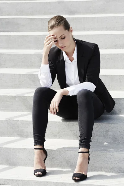 Businesswoman sitting on steps