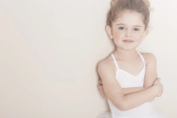 Young ballerina with arms folded
